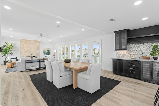 1895 Bay Shore Dr, Rockport, TX 78382 - dining space with light wood-style floors, ceiling fan, visible vents, recessed lighting, and indoor bar