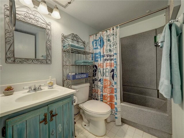 3938 Surfside Blvd Unit 3344, Corpus Christi, TX 78402 - full bath featuring toilet, vanity, tile patterned flooring, a textured wall, and shower / bathtub combination with curtain