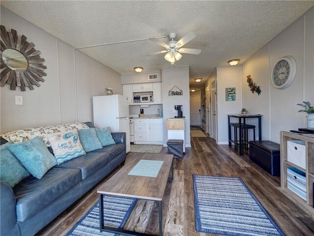 3938 Surfside Blvd Unit 3344, Corpus Christi, TX 78402 - living area with dark wood-style floors, ceiling fan, and a textured ceiling