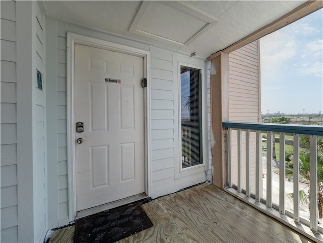 view of exterior entry featuring a balcony