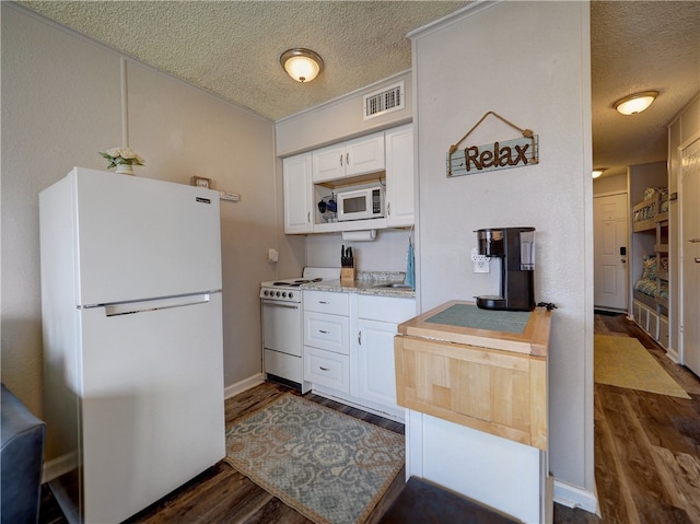 kitchen featuring dark hardwood / wood-style flooring, white cabinetry, and white appliances