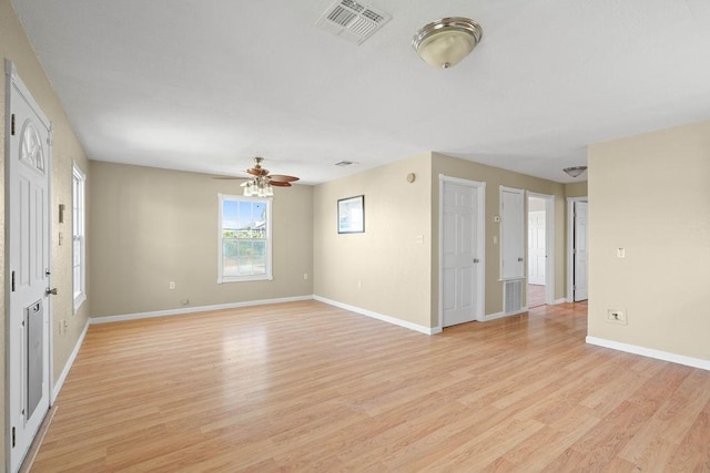 spare room featuring visible vents, light wood-style flooring, and baseboards