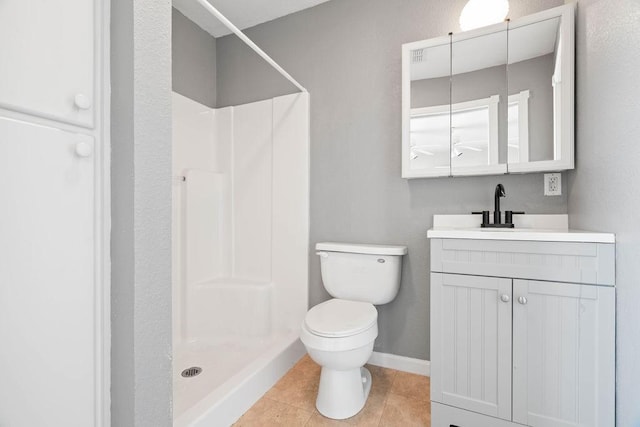 full bath with toilet, vanity, baseboards, tile patterned floors, and a stall shower