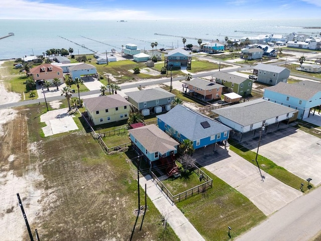 drone / aerial view with a water view and a residential view