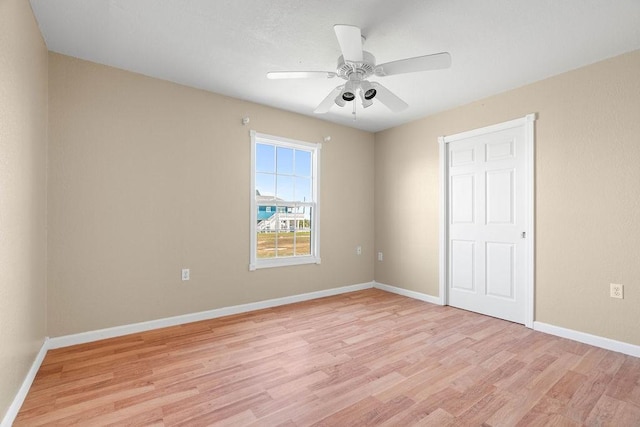 unfurnished bedroom with a ceiling fan, baseboards, and light wood finished floors