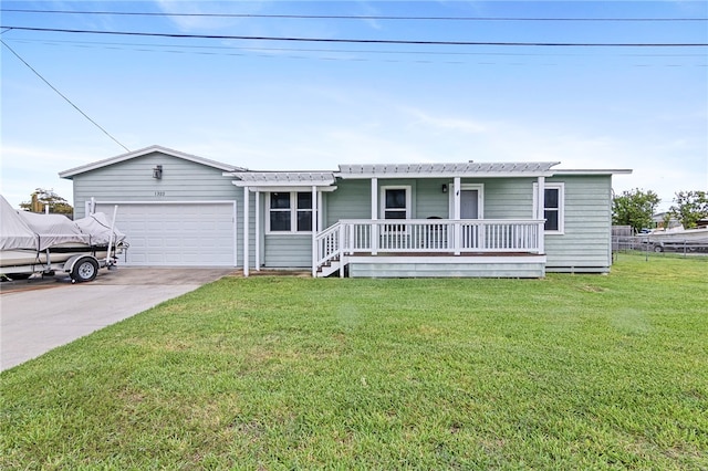 ranch-style home with a garage, a front yard, and covered porch