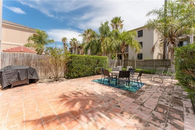 103 E Palmetto Dr Unit B, South Padre Island, TX 78597 - fenced backyard with a patio, area for grilling, and outdoor dining space