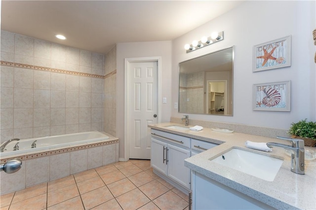 103 E Palmetto Dr Unit B, South Padre Island, TX 78597 - bathroom featuring double vanity, tile patterned flooring, tiled tub, and recessed lighting