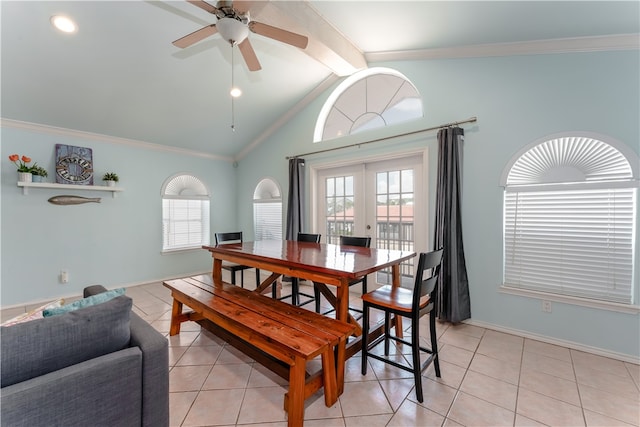 dining space with french doors, a healthy amount of sunlight, light tile patterned floors, and lofted ceiling with beams