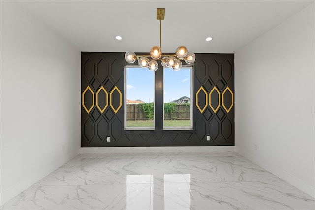 unfurnished dining area featuring a notable chandelier