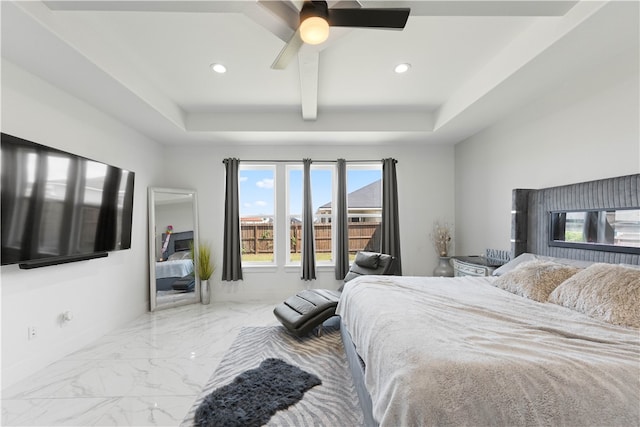 bedroom with beamed ceiling, a tray ceiling, and ceiling fan