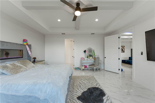 bedroom with ceiling fan and a tray ceiling