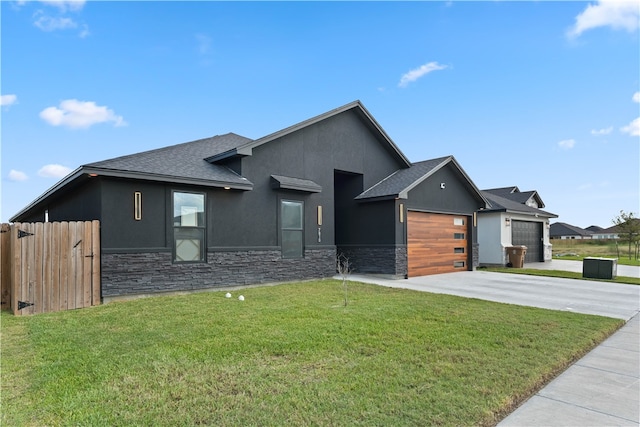 view of front of property featuring a garage and a front yard