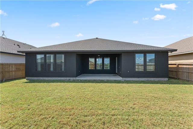 back of property with a patio and a yard