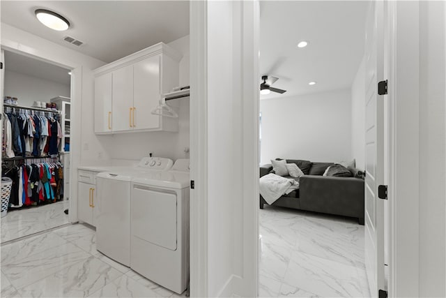 washroom with cabinets, independent washer and dryer, and ceiling fan