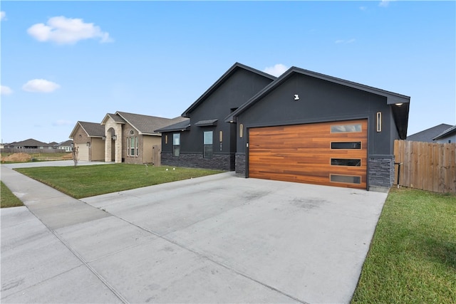 view of front facade with a garage and a front lawn