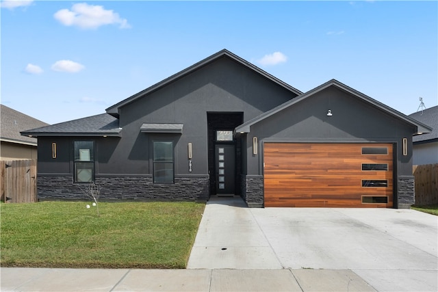 view of front of home with a garage and a front yard