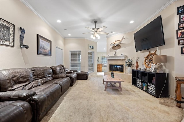 living room featuring carpet, a fireplace, ceiling fan, and crown molding