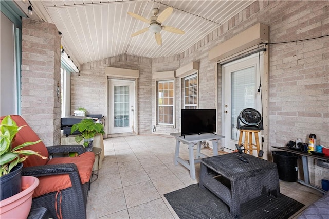 sunroom / solarium featuring ceiling fan, wooden ceiling, and vaulted ceiling