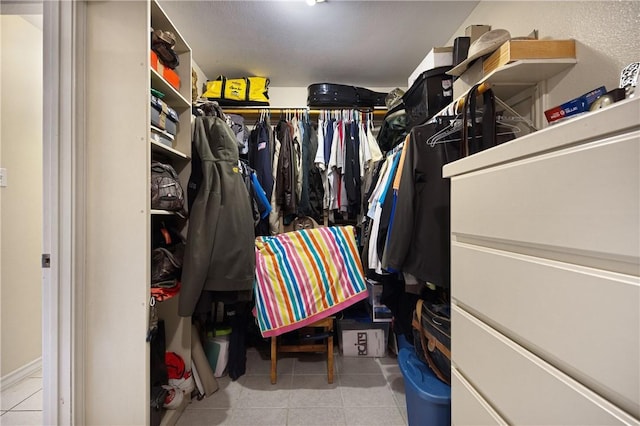 spacious closet with light tile patterned floors