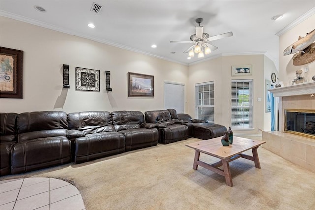 living room featuring a fireplace, light colored carpet, ceiling fan, and ornamental molding