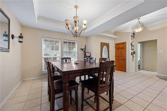 tiled dining area featuring a notable chandelier, a raised ceiling, and crown molding