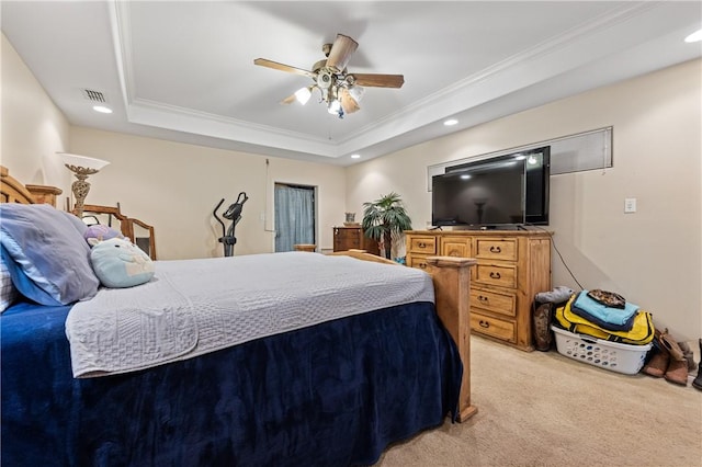 carpeted bedroom featuring a raised ceiling, ceiling fan, and ornamental molding