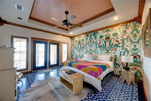 bedroom with ceiling fan, access to exterior, ornamental molding, and a raised ceiling