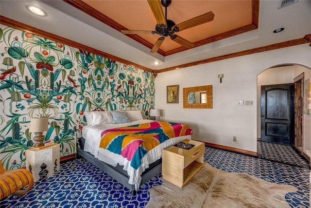 bedroom featuring ceiling fan, carpet, a tray ceiling, and crown molding