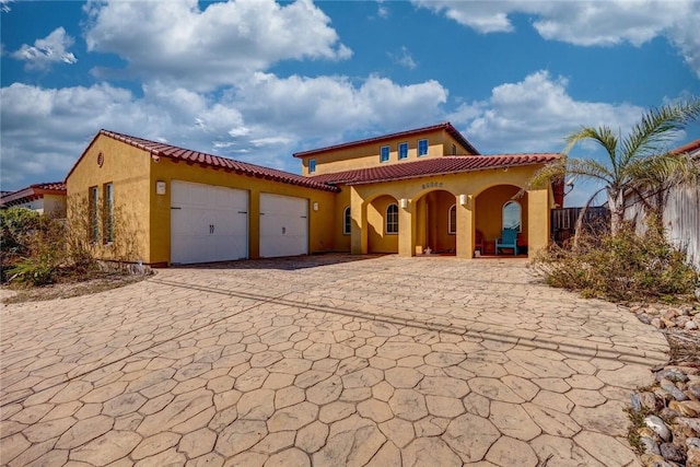 mediterranean / spanish home with a garage