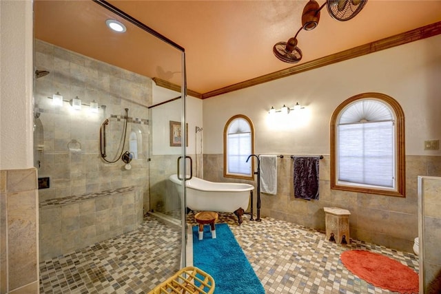 bathroom featuring tile patterned flooring, tile walls, crown molding, and plus walk in shower