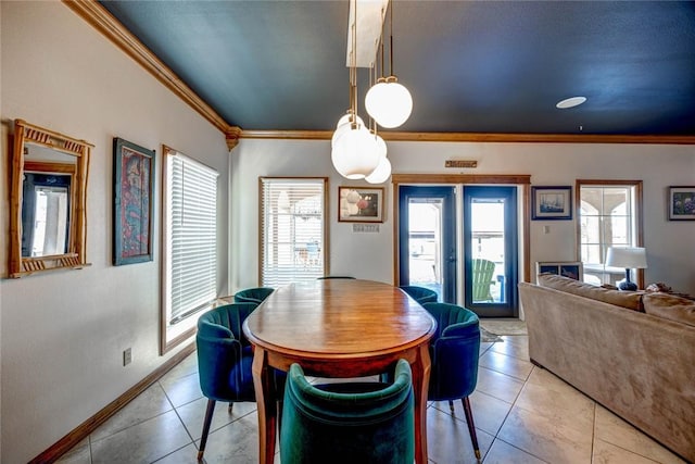 dining area with light tile patterned floors, ornamental molding, and a healthy amount of sunlight