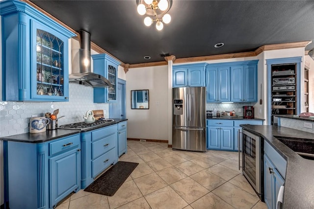 kitchen with range hood, crown molding, appliances with stainless steel finishes, blue cabinets, and beverage cooler