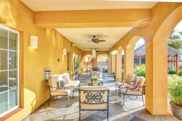 patio terrace at dusk with a water view, a gazebo, and a bar