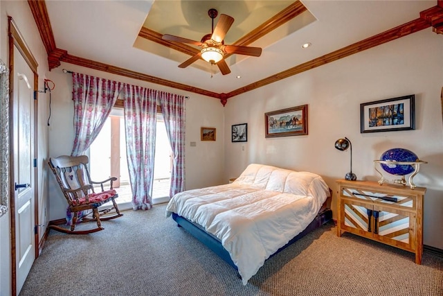 bedroom with ceiling fan, carpet floors, ornamental molding, and a raised ceiling