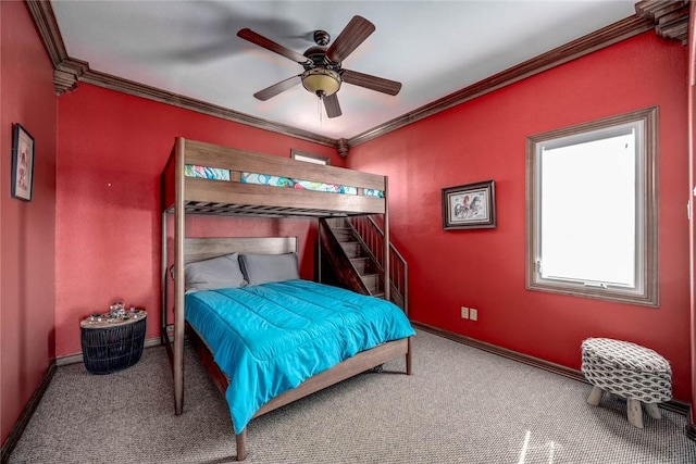 bedroom with ceiling fan, ornamental molding, and carpet flooring