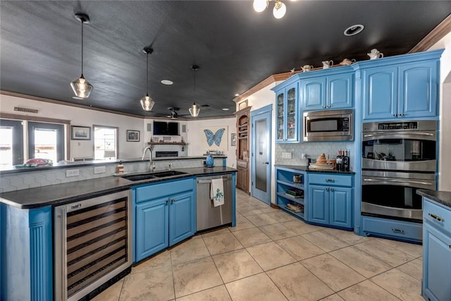 kitchen featuring blue cabinets, sink, and stainless steel appliances