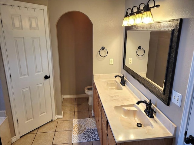 2022 Jenica Dr, Ingleside, TX 78362 - bathroom with double vanity, tile patterned flooring, and toilet
