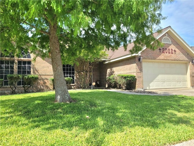 2022 Jenica Dr, Ingleside, TX 78362 - view of front of house featuring brick siding, a garage, and a front yard