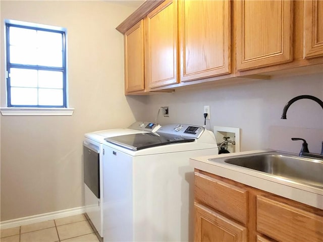 2022 Jenica Dr, Ingleside, TX 78362 - laundry area with independent washer and dryer, cabinet space, light tile patterned flooring, and baseboards