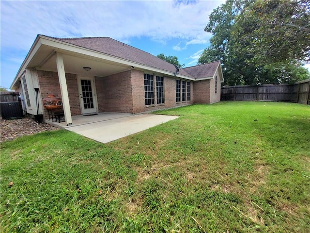 2022 Jenica Dr, Ingleside, TX 78362 - back of property with brick siding, a patio, central AC, and a shingled roof