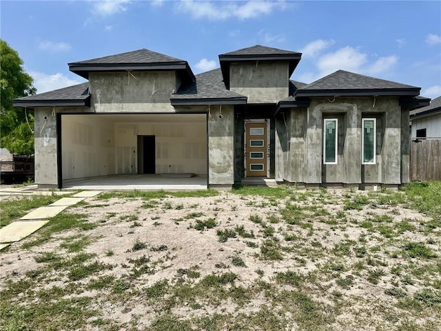 rear view of property featuring an attached garage