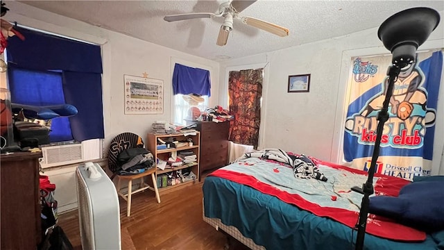 4049 Laguna Shrs, Corpus Christi, TX 78418 - bedroom with a textured ceiling, wood finished floors, ceiling fan, and cooling unit