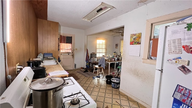 kitchen featuring sink, tile counters, a textured ceiling, and white refrigerator