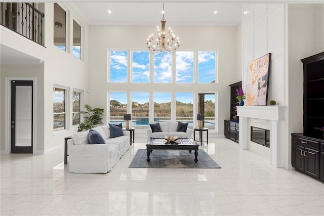 living area featuring baseboards, a chandelier, recessed lighting, a fireplace, and marble finish floor