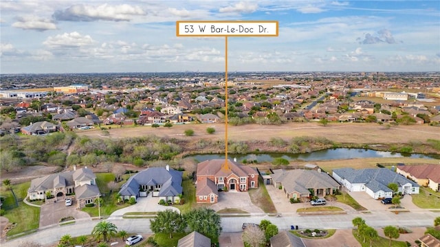 drone / aerial view with a residential view and a water view