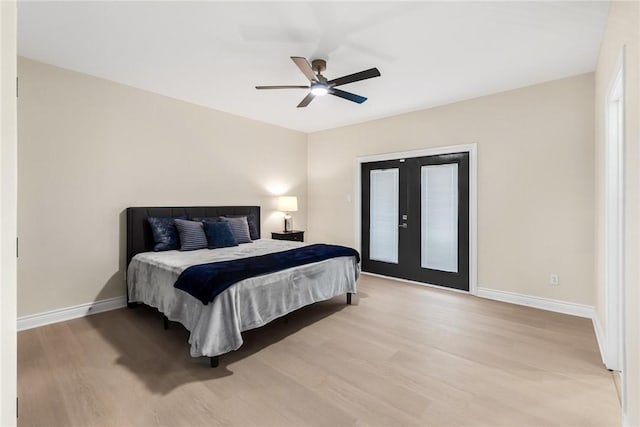 bedroom featuring a ceiling fan, baseboards, light wood-style flooring, french doors, and access to outside