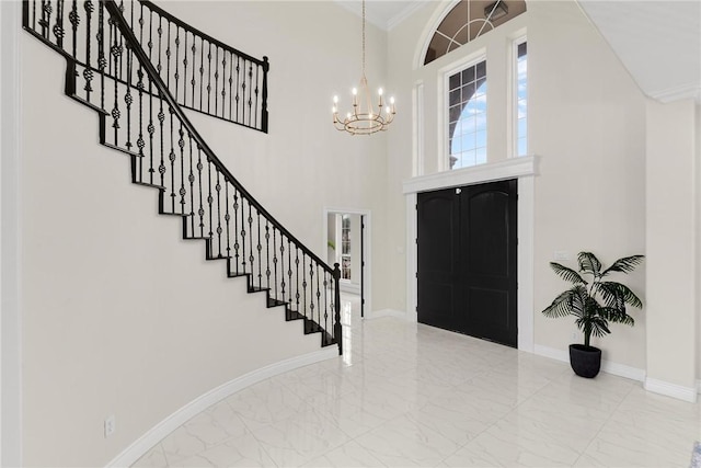 foyer featuring a notable chandelier, baseboards, and marble finish floor