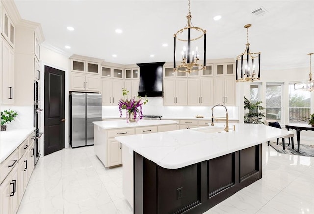 kitchen with a spacious island, a sink, stainless steel refrigerator, extractor fan, and a chandelier