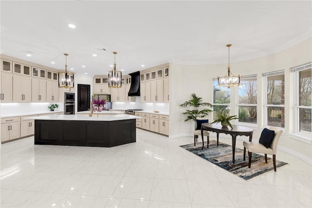 kitchen featuring a notable chandelier, ornamental molding, light countertops, and custom range hood